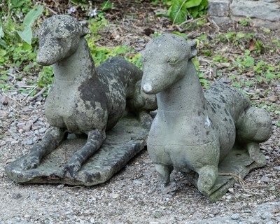 Lot 1251 - Pair of cast reconstituted stone resting hounds