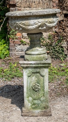 Lot 1259 - A cast reconstituted stone garden urn together with a square section plinth