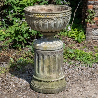 Lot 1258 - A cast reconstituted stone garden urn together with a circular plinth and fluted column support