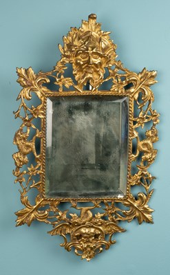 Lot 238 - A solid gilt brass mirror