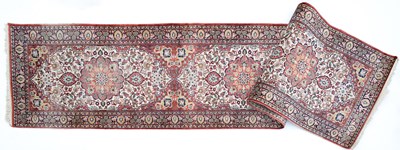 Lot 1052 - An Indian red ground runner