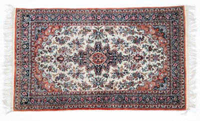 Lot 1050 - An Eastern red ground silk rug