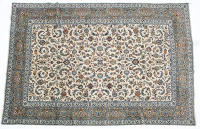 Lot 1072 - A Middle Eastern Kashan cream ground carpet