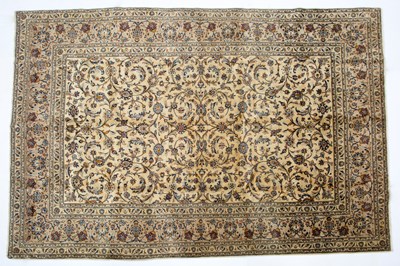 Lot 1071 - A Middle Eastern Kashan cream ground carpet