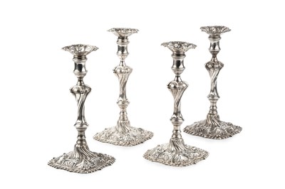 Lot 838 - A set of four George II silver candlesticks,...