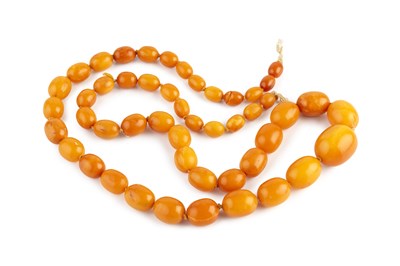 Lot 225 - An amber bead necklace, the single strand of...