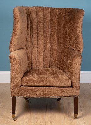 Lot 128 - An antique wingback armchair