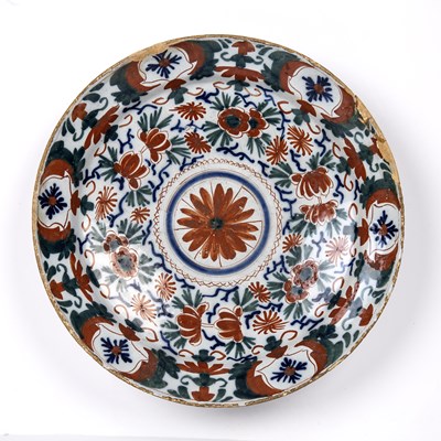 Lot 114 - An 18th century Delft charger with red, blue...