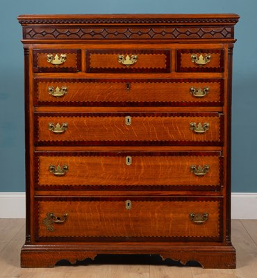 Lot 137 - A 19th century oak chest of three short and four long graduated drawer