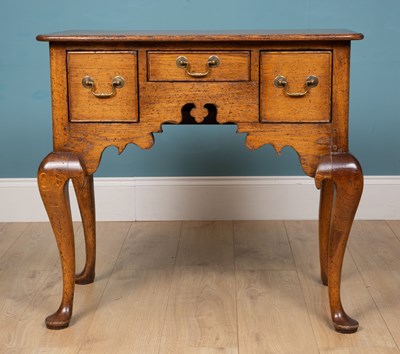 Lot 164 - A George III style oak low boy