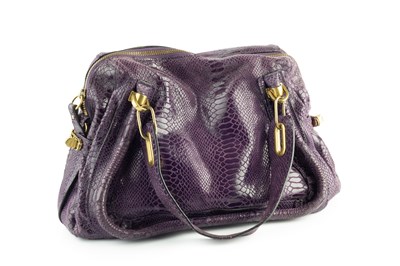 Lot 145 - A purple handbag by Chloé, and a cream handbag...