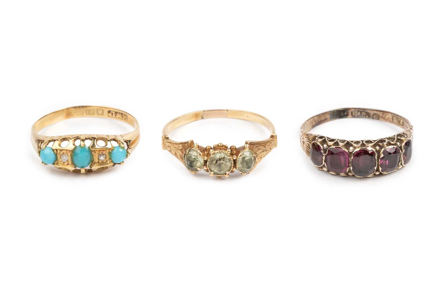 Lot 64 - Three dress rings, comprising a three stone...