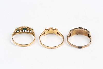 Lot 64 - Three dress rings, comprising a three stone...