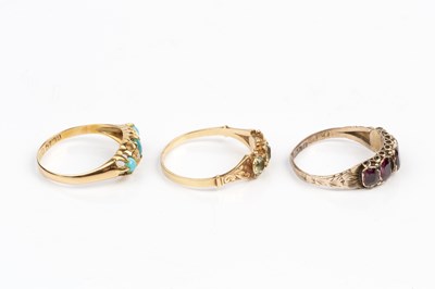 Lot 64 - Three dress rings, comprising a three stone...