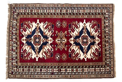 Lot 1055 - A Middle Eastern red ground woolen rug