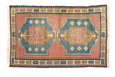 Lot 1043 - A mid to late 20th century Turkish cream, red and blue ground woolen rug