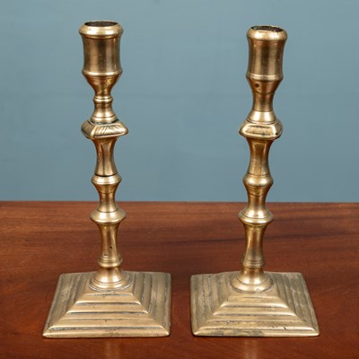 Lot 11 - A pair of Georgian brass candlesticks
