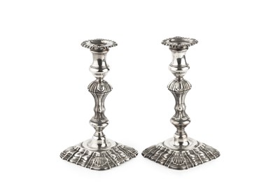 Lot 567 - A pair of George II silver candlesticks, with...