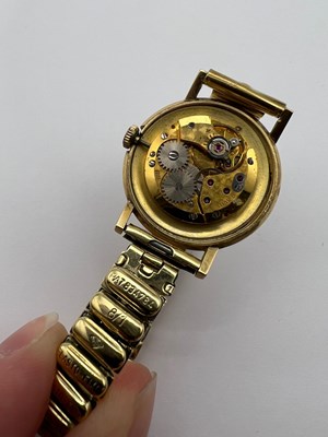 Lot 194 - A yellow precious metal bracelet watch, the...
