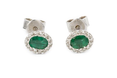 Lot 48 - A pair of emerald and diamond cluster ear...