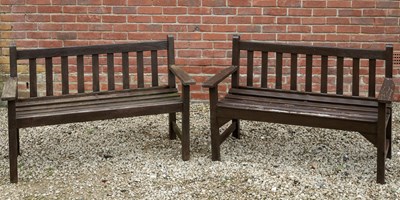 Lot 1126 - A pair of teak brown stained garden benches