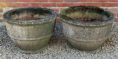 Lot 1103 - A pair of cast reconstituted stone urns