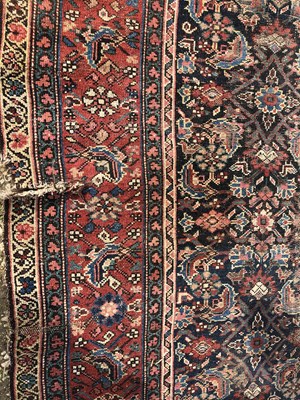Lot 18 - An antique Oriental blue ground rug