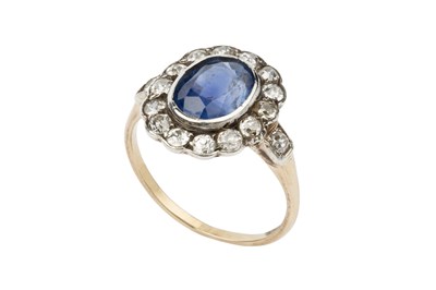 Lot 136 - A sapphire and diamond cluster ring, the oval...