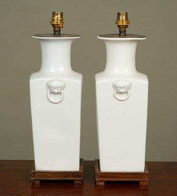 Lot 444 - A pair of white glazed ceramic lamp stands