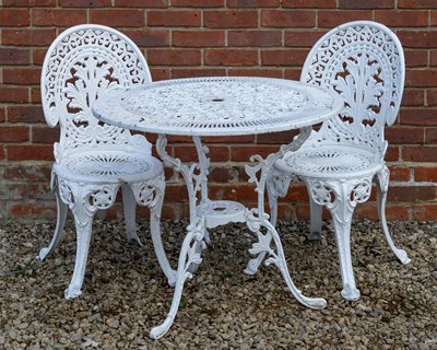 Lot 1114 - A cast aluminium circular garden table and two chairs