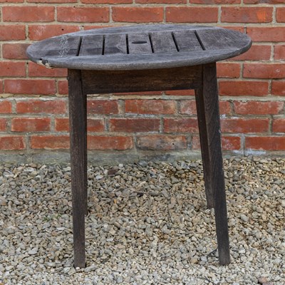 Lot 1212 - A small circular teak garden table