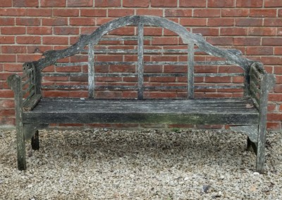 Lot 1130 - A Lutyens style teak garden seat