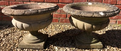 Lot 1217 - A pair of cast reconstituted stone urns