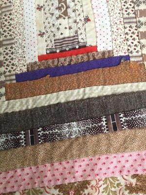 Lot 157 - A late Victorian patchwork quilt with rows of...