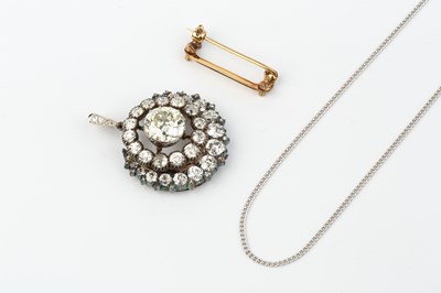 Lot 147 - A diamond cluster pendant/brooch, centred with...