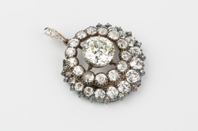 Lot 147 - A diamond cluster pendant/brooch, centred with...