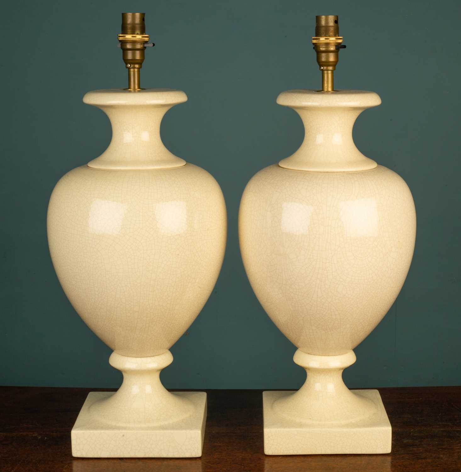 Lot 14 - A pair of cream crackle baluster shaped table lamps