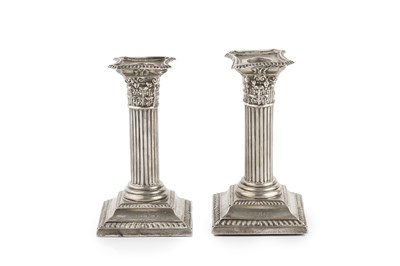 Lot 575 - A pair of Edwardian silver candlesticks, with...