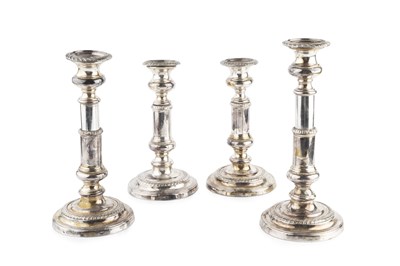 Lot 230 - A set of four silver plated candlesticks, with...