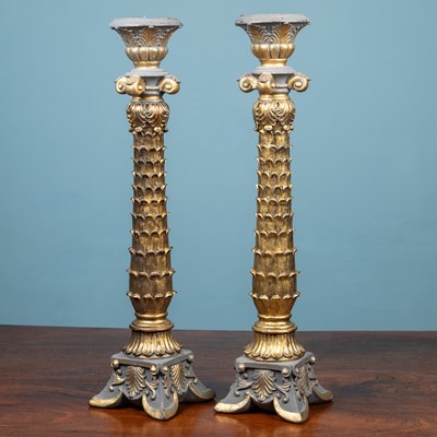 Lot 63 - A pair of tall ornately carved gilt candlestick holders