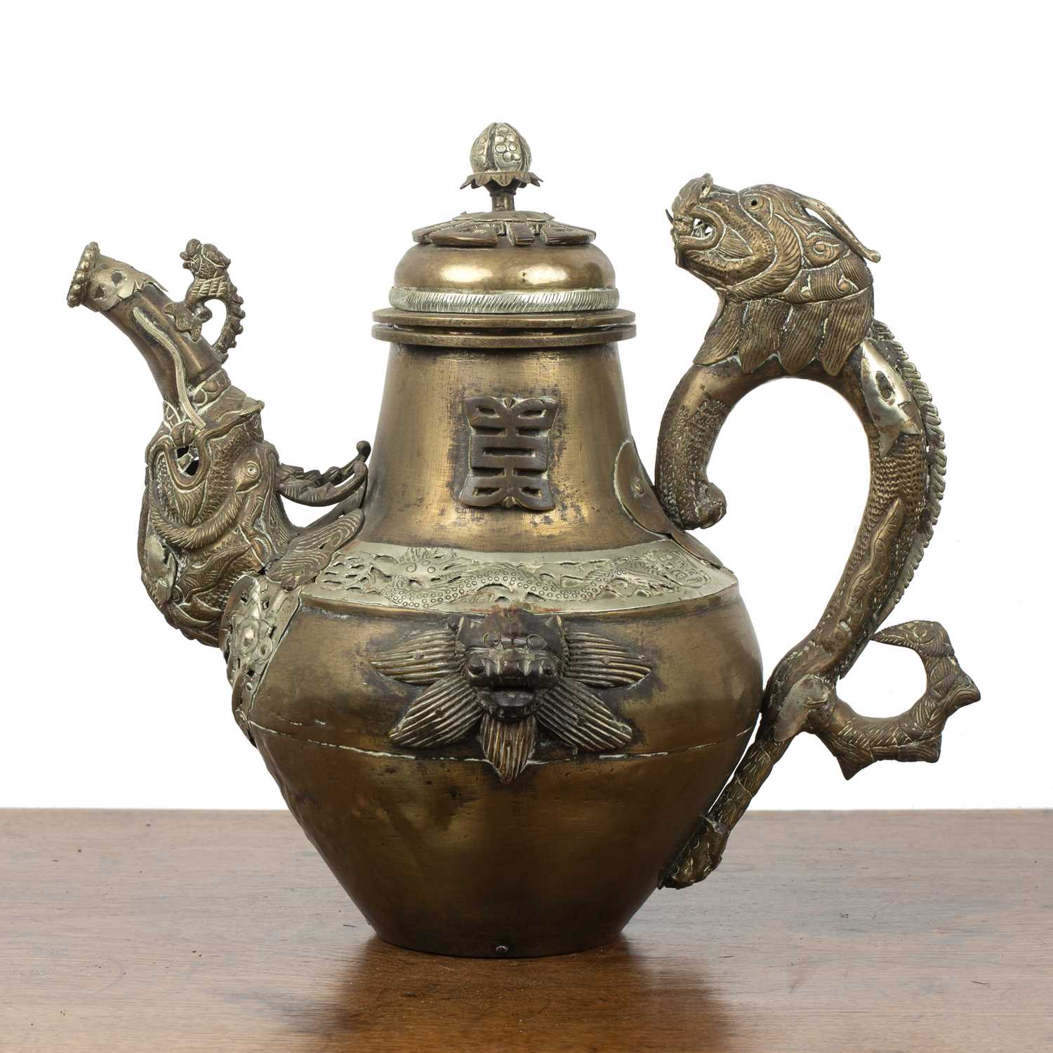 Lot 311 Brass and embossed metal teapot Tibetan with