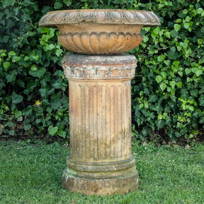 Lot 1300 - An antique terracotta urn plinth together with a terracotta shallow campana urn bowl