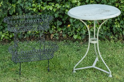 Lot 1269 - A green painted circular iron garden table and a wire work conservatory two-tier plant stand