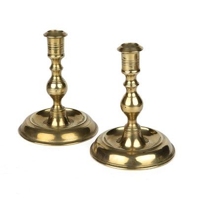 Lot 337 - A pair of antique Spanish brass candlesticks...