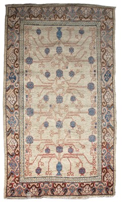 Lot 275 - An antique cream ground Khotan rug 123cm x 227cm