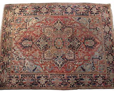 Lot 309 - An antique Heriz red ground carpet with...