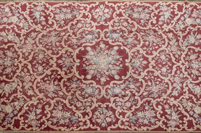 Lot 1048 - A red ground Kidderminster Axminster carpet