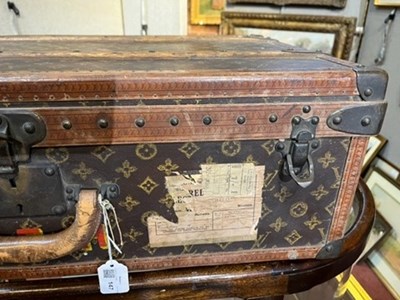 Lot 147 - A Louis Vuitton suitcase, with studded leather...