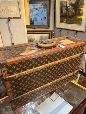 Lot 147 - A Louis Vuitton suitcase, with studded leather...