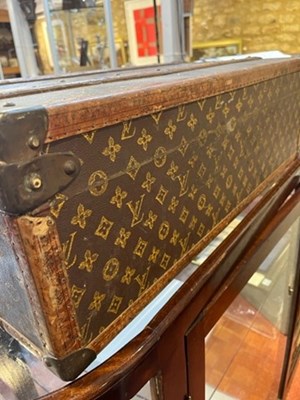 Lot 147 - A Louis Vuitton suitcase, with studded leather...